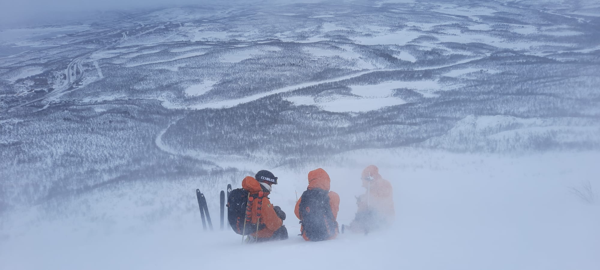 picture of three female ski patrol doing avalanche control